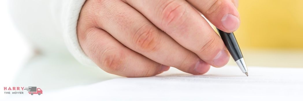 10 Questions That Every Client Should Ask Removalist Company 5 Close-up of a hand signing moving insurance documentation for Harry The Mover in Melbourne.